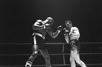 In this Feb. 23, 1965 file photo, Rubin "Hurricane" Carter, left, knocks out Italian boxer Fabio Bettini in the 10th and last round of their fight at the Falais Des Sports in Paris. Carter, who spent almost 20 years in jail after twice being convicted of a triple murder he denied committing, died at his home in Toronto, Sunday, April 20, 2014.