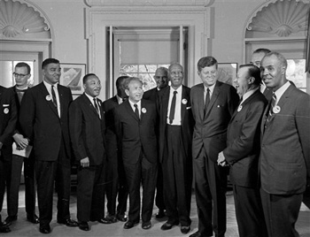 In this Aug. 28, 1963 file photo, President Kennedy stands with a group of leaders of the March on Washington at the White House in Washington. Immediately after the march, they discussed civil rights legislation that was finally inching through Congress.