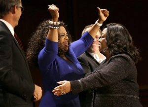 Actor, talk show host and philanthropist Oprah Winfrey, center left, and television producer and writer Shonda Rhimes, right, embrace on stage during the W.E.B. Du Bois medal award ceremonies, Tuesday, Sept. 30, 2014, on the campus of Harvard University, in Cambridge, Mass. The Du Bois Medal is Harvard's highest honor in the field of African and African American Studies. Winfrey and Rhimes both received the medal.