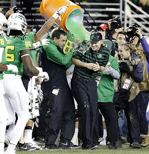 Oregon coach Mark Helfrich is drenched with a green liquid during the second half of a Pac-12 Conference championship against Arizona NCAA college football game Friday, Dec. 5, 2014, in Santa Clara, Calif. Oregon won, 51-13.