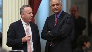 Senate President Pro Tem Darrell Steinberg, D-Sacramento, left, talks with Sen. Ed Hernandez, D-Covina at the Capitol in Sacramento, Calif., Monday, April 21, 2014. Hernandez proposed a constitutional amendment that would ask voters to again allow public colleges to use race and ethnicity when considering college applicants. The proposal stalled this year after backlash from Asian Americans.