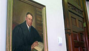 A painting of U.S. District Judge Waites Waring, one of three federal judges to hear a key school desegregation case from Clarendon County, S.C., in 1951, hangs in the courtroom where the case was again heard in the federal courthouse in Charleston, S.C., on April 3, 2014. Waring was the first judge to write an opinion that separate schools are not equal schools since separate but equal became the law of the land in the late 1800s.