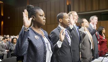 Witnesses, from left, Sybrina Fulton, mother of Trayvon Martin; Ronald S. Sullivan, Jr., Clinical Professor of Law, Director of the Criminal Justice Institute, Harvard Law School; David LaBahn, Association of Prosecuting Attorneys president and CEO; Ilya Shapiro, Senior Fellow in Constitutional Studies at Cato Institute; John R. Lott, Jr., president, Crime Prevention Research Center of Swarthmore, Pa.; and Lucia McBath of Atlanta, Ga.; are sworn in on Capitol Hill in Washington, Tuesday, Oct. 29, 2013.