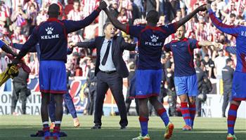 Levante's coach Joaquin Caparros and his players celebrate their victory against Atletico de Madrid at theCiutat de Valencia stadium in Valencia, Spain, on Sunday, May 4, 2014.