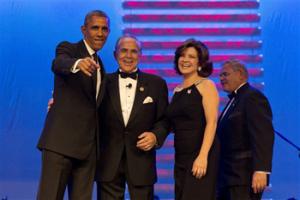 President Barack Obama, left, points toward a camera with chairman of the Congressional Hispanic Caucus Rep. Ruben Hinojosa, D-Texas, Marty Hinojosa, and Sen. Bob Menendez, D-N.J., at the Congressional Hispanic Caucus Institute’s 37th Annual Awards Gala at the Walter E. Washington Convention Center in Washington, Thursday, Oct. 2, 2014.